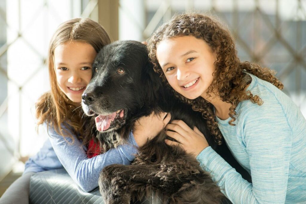NEXT residents Vivian and Olivia Sampson with Daisy the House Dog. 
