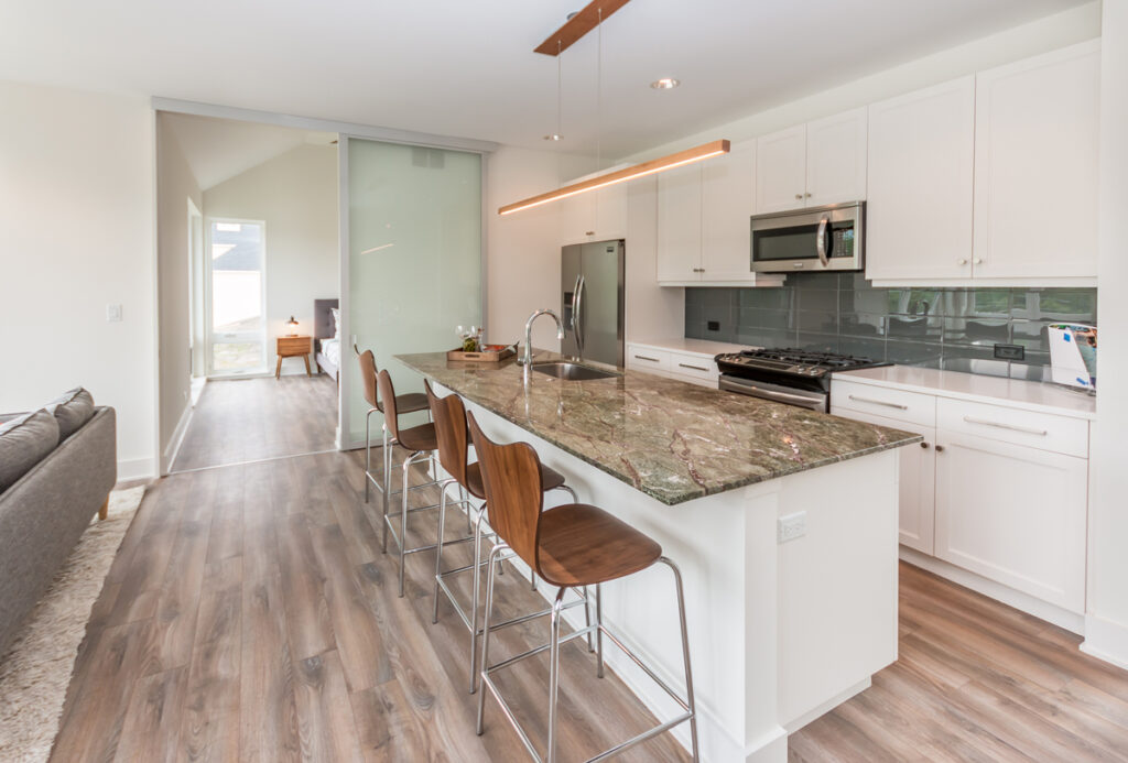 At Heritage Harbor Ottawa Resort in Ottawa, Ill., a sliding glass barn-style door between the master bedroom and the kitchen adds to the modern, light-filled aesthetic of the community’s Flite series townhome.