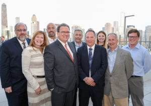 Executives from Ascend Real Estate Group celebrate the grand opening of Niche 905, an 18-story, 202-unit luxury apartment tower on Chicago’s Near North Side.