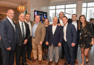 Executives from Intercontinental Real Estate Corporation gather in the 18th-floor entertainment suite during the grand opening celebration for Niche 905.