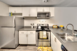 As part of its renovation of The Clayson, an apartment community in Palatine, Ill., Draper and Kramer added modern kitchens with white shaker-style cabinets, granite countertops and stainless steel appliances.