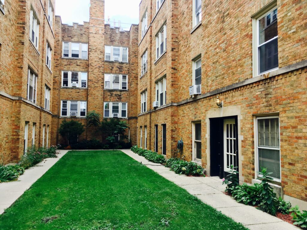 Managed by Kass Management, this 100 year-old rental building located in Portage Park includes vintage details like antique stained wood doors and midcentury historic trim tile in the bathrooms.