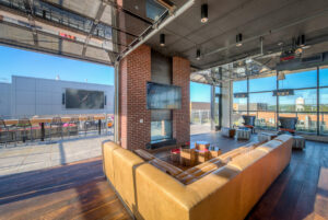 Multiple gathering spaces and a mega-screen television on the rooftop at AVA NoMa bring residents together to watch movies or televised sporting events.